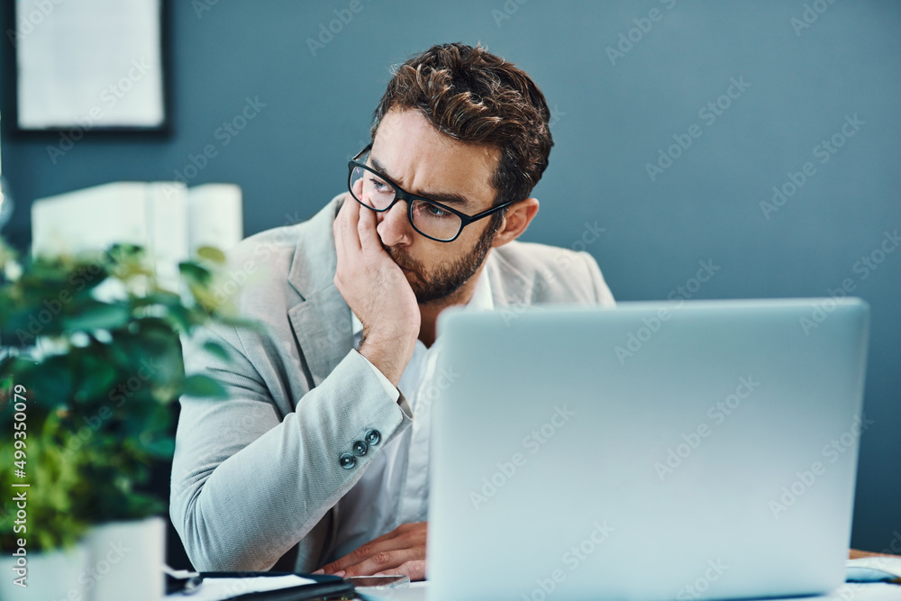 Aufkleber How did this day turn into such a big stress. Shot of a young businessman looking stressed out while working on a laptop in an office.