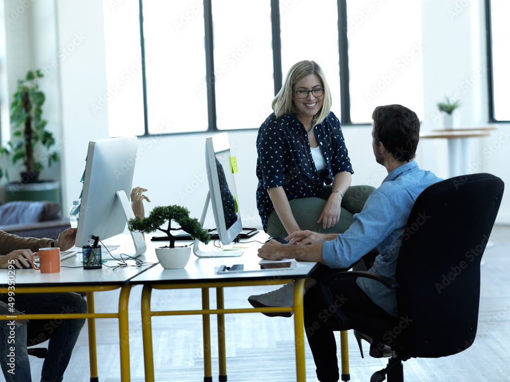 Poster so hows your project coming along. cropped shot of two business colleagues chatting at a desk in the