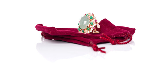 Aquamarine with Emerald, Ruby and white Zircon ring on red velvet bag. Collection of natural...