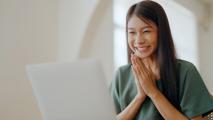 Excited asian female feeling euphoric celebrating online win success achievement result, young...