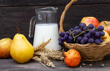 pitcher with milk, cheese wheat and fruits Shavuot concept