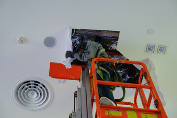 Install fire sprinkler system. In the industrial plant, pipe assembly, red fire pipe, fire protection contractors Using Scissor Lift High work