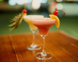 Expertly mixed. Shot of two fruity cocktails on a table in a bar.