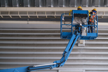 Install fire sprinkler system. In the industrial plant, pipe assembly, red fire pipe, fire protection contractors Using Scissor Lift High work
