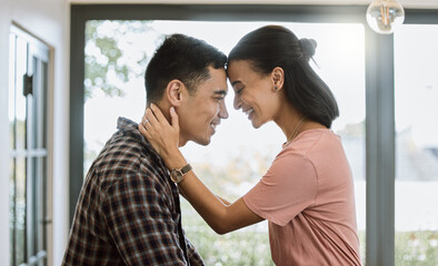 Love is when you accept someones flaws. Shot of a couple spending time together in the kitchen at home.