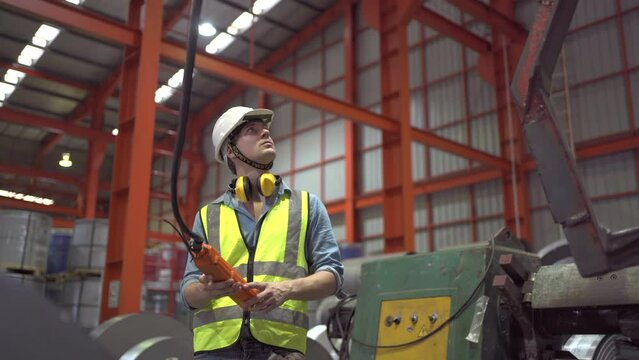 Industrial engineer control the machine by using remote control.