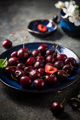 Fresh ripe cherry on blue plate close up