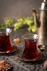 Turkish tea in traditional glass closeup on tile background