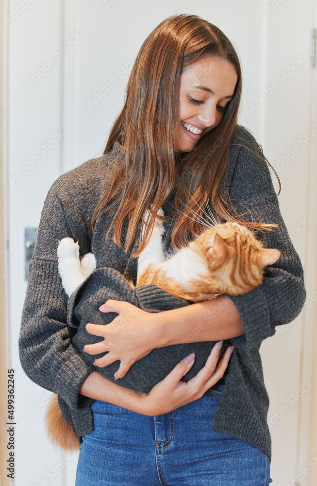 Poster I just want to be a stay-at-home cat mom. Shot of a young woman carrying her cat at home.