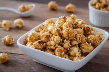 Popcorn with caramel in white bowl