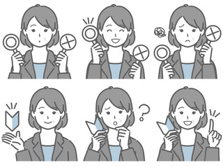 〇✕マークや初心者マークを持つスーツの中年女性