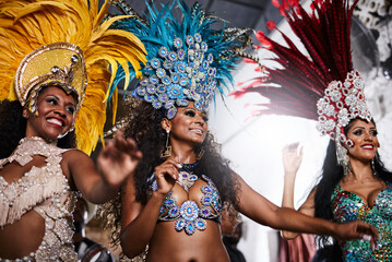 Stealing the show with their dazzling performances. Shot of samba dancers performing in a carnival.