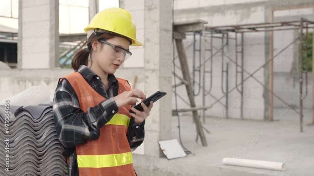 Poster asian architect engineer worker woman in protective helmet and uniform using smart phone mobile app 