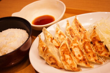 Gyoza or dumplings snack with soy sauce and rice - 餃子 醤油 ご飯
