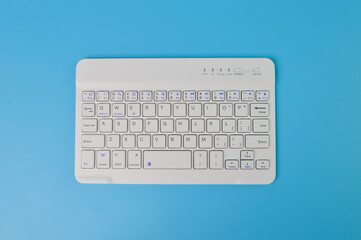 Computer keyboard isolated on a blue background