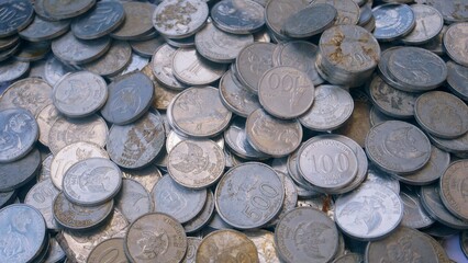 Pile of Indonesian rupiah coins on white background, slight bright light