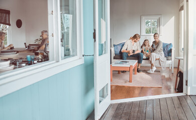 Nothing goes better than coffee and good company. Shot of a young couple and their daughter sitting together at home.