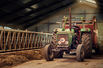 Obraz premium Old faithful. Shot of a rusty old tractor standing in an empty barn.