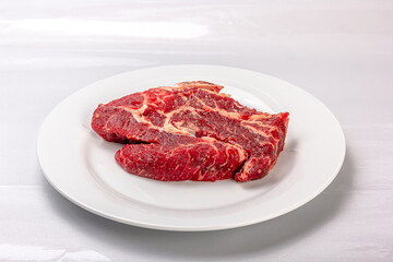 Raw marbled beef on a a white background