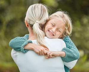 I want to hold on and never let go. Shot of a little girl and her mother sharing a hug while...