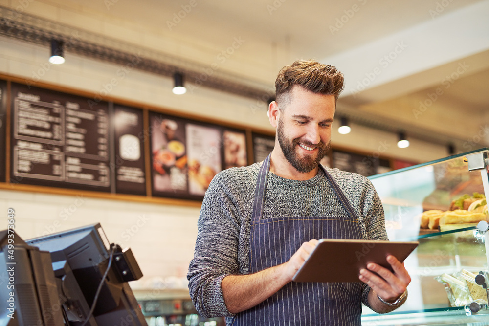 Aufkleber hes just launched an app for his business. cropped shot of a business owner using a digital tablet i