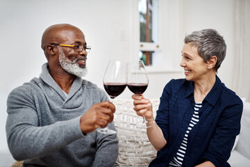 Were always celebrating our love for each other. Shot of an affectionate senior couple enjoying some wine together at home.