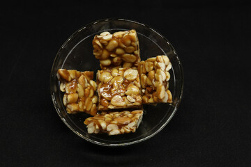 Peanut candy is in a bowl. with Black background