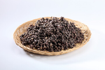 oriental raisin tree fruits and leaves in a basket isolated on a white background