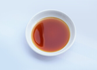 Fish sauce in white bowl isolated on background. Phu Quoc Traditional Fish Sauce.