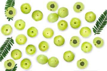 Indian gooseberry fruits (Amla, phyllanthus emblica) with green leaves isolated on white background. Top view. Flat lay.