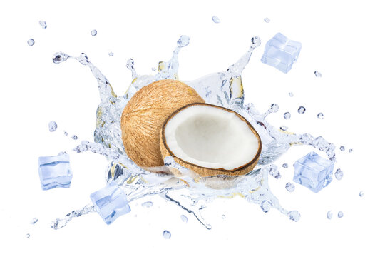 Coconut water splashing from brown coco nut fruit with ice cubes isolated on white background.