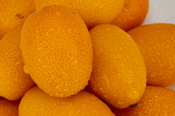 kumquats isolated in white background - shot using studio lights. 