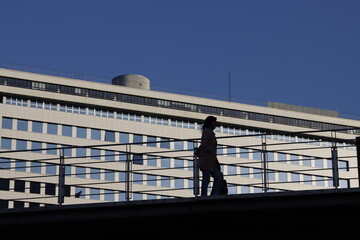 silhouette of a person on a bridge