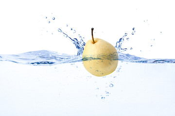 Yellow pear fruit falling in water with splash isolated on white background.