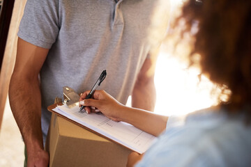 I just need you to fill in some details. Closeup shot of a woman signing for her delivery from the courier.