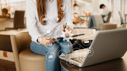 Fototapeta premium Hands of woman using mobile phone in modern office with laptop and digital tablet computer with VR icon