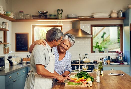 Home cooked happiness. Shot of a happy mature couple cooking a meal together at home.