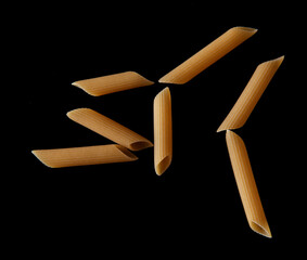 Dried pasta isolated on black background.