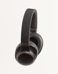 Black audio headphones isolated on white background.
