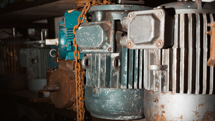 Close-up of electric motors on shelf in garage, selective focus. Industrial electrical equipment,...