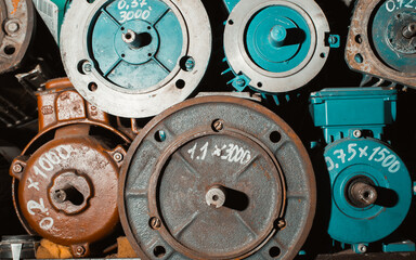 Close-up of group of electric motors, stator and rotor on shelf in garage. Industrial electrical equipment, technologies