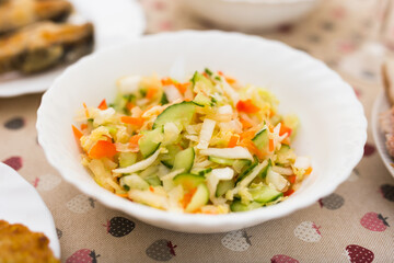 chopped cabbage, tomatoes, cucumbers, onions and herbs in a bowl