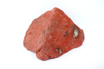 Macro shooting of raw specimen red jasper rock isolated on white background.