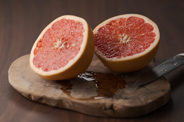 Naklejka na ściany i meble Ripe grapefruit on wood board closeup
