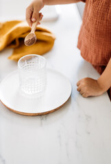 The children make glass of hot cocoa, closeup soft focus. Hot milk beverage. Breakfast drink.
