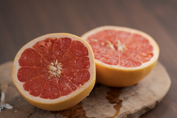 Ripe grapefruit on wood board closeup
