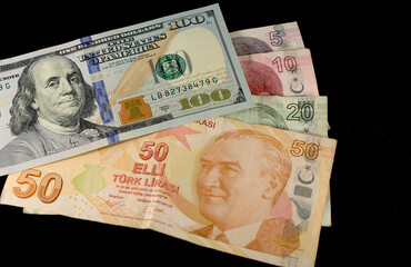 Turkish lira banknotes and American dollars on a black background
