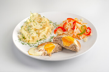 Сlose up Homemade fried Fish Or Chicken Cutlets with egg, mashed potatoes and salad with sauerkraut on white plate isolated. Banner menu recipe.