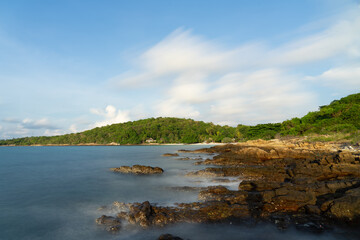 Fototapeta na wymiar Sunrise with rock beach and smooth wave effect at Samet Island, Thailand