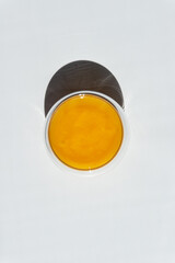 texture of golden honey in a transparent container on a white background free space for text.sunflower honey